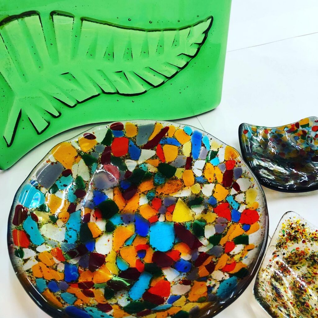 Glass Frit bowls and dishes and a beautiful green kiln carved fern wave, just some of the ideas you could be making at Rainbow Glass Studios on our Beginners day course