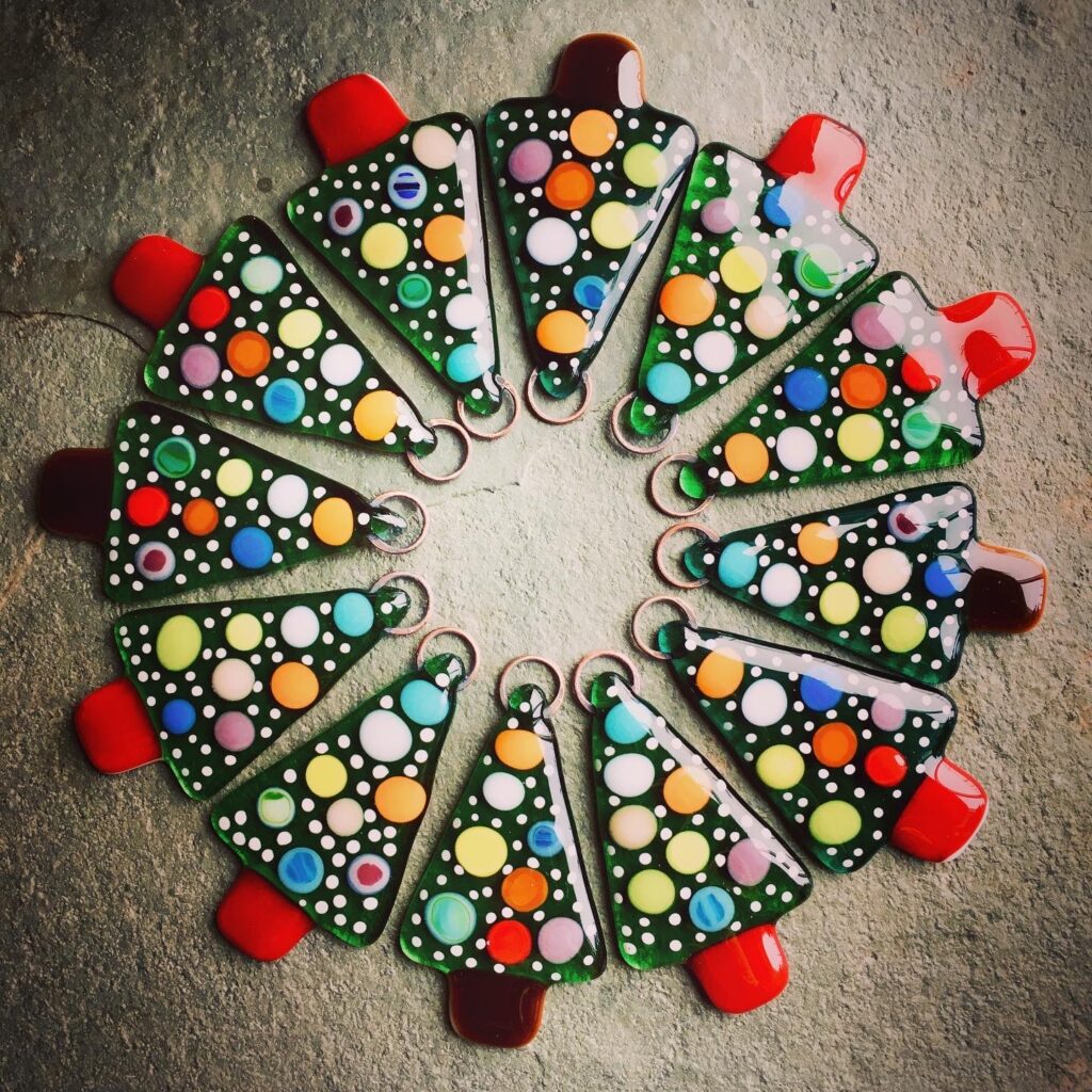 A carousel of Fused Glass Spotty Christmas Tree decorations - a design by Eleanor Watson at Rainbow Glass Studios