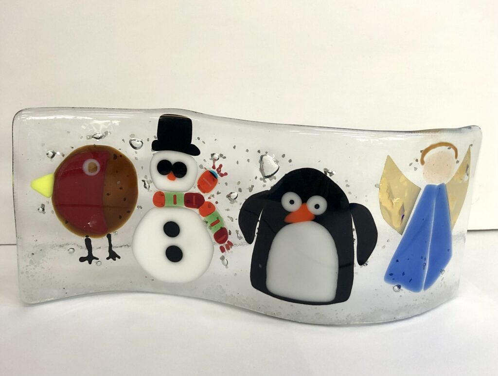 Fused Glass Christmas wave with four characters - a robin, a snowman a penguin and an angel - made at Rainbow Glass Studios