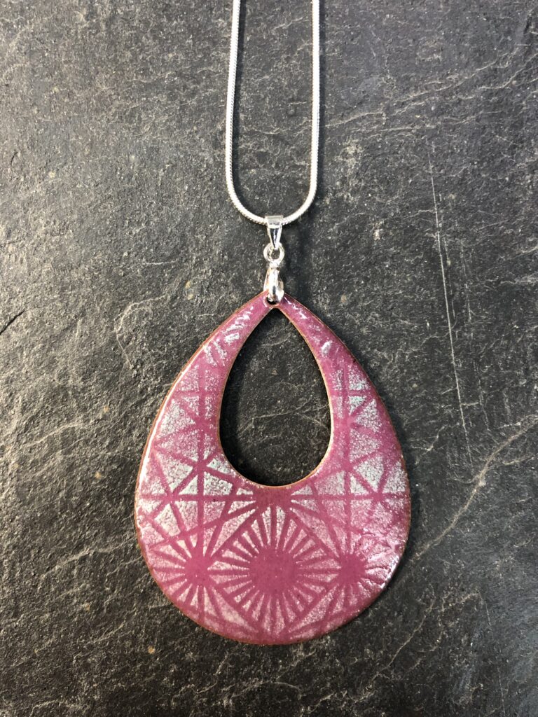A beautiful raindrop shaped donut pendant in dusky pink with a pale blue and cream pattern - a superb used of stencilling by a beginning on our day course at Rainbow Glass Studios