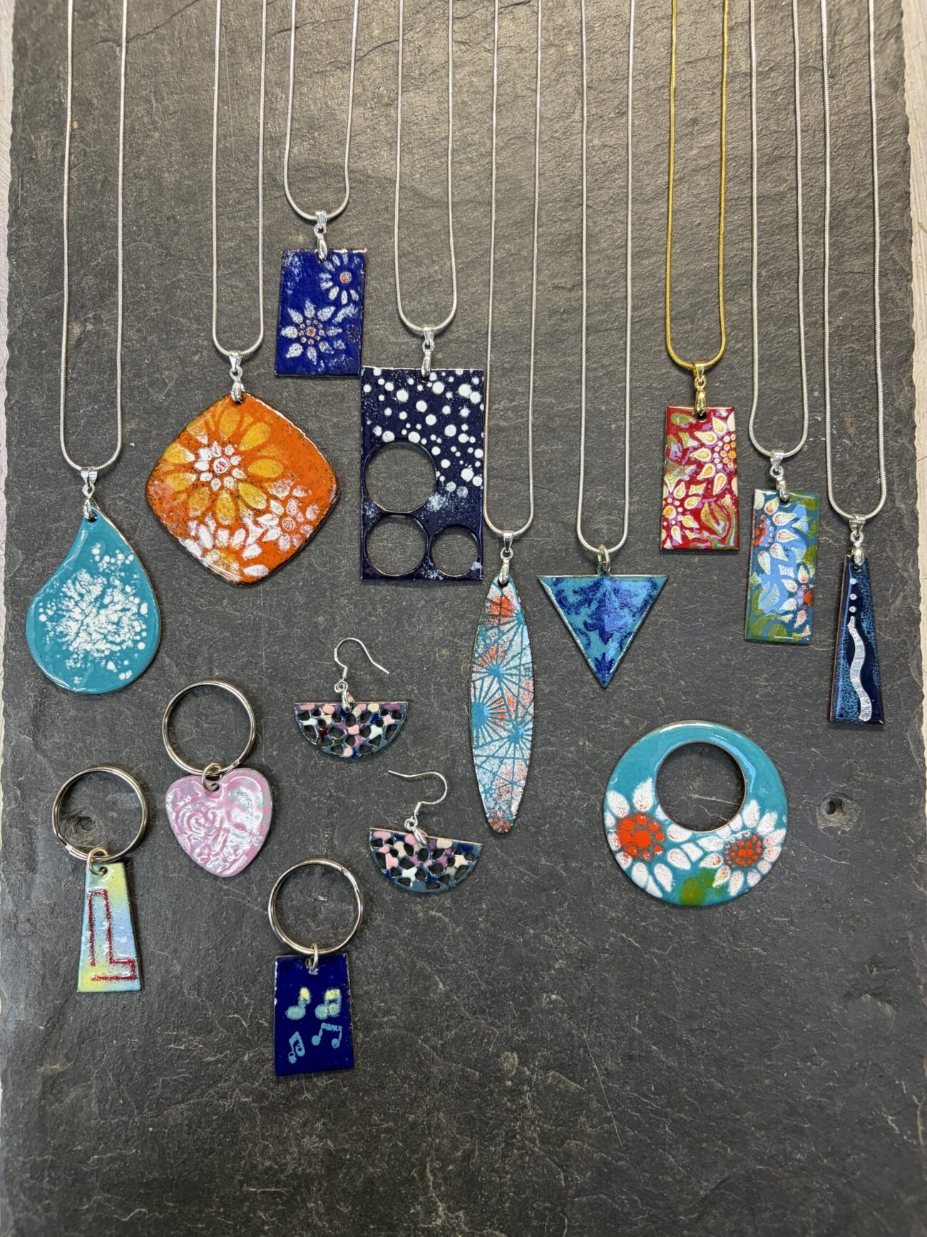 An array of 4 student's work from one day at Rainbow Glass Studios on the Enamelling on Copper Introductory Day Course - they wore them home!