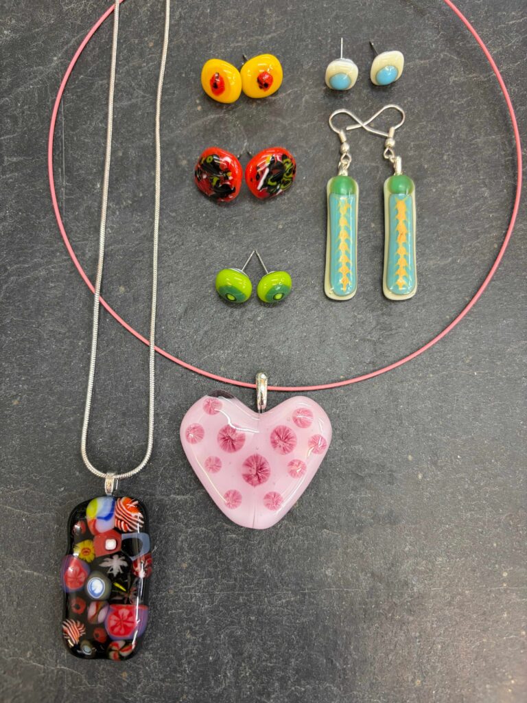 A colourful collection of fused glass jewellery made at the day course for beginners at Rainbow Glass Studios
