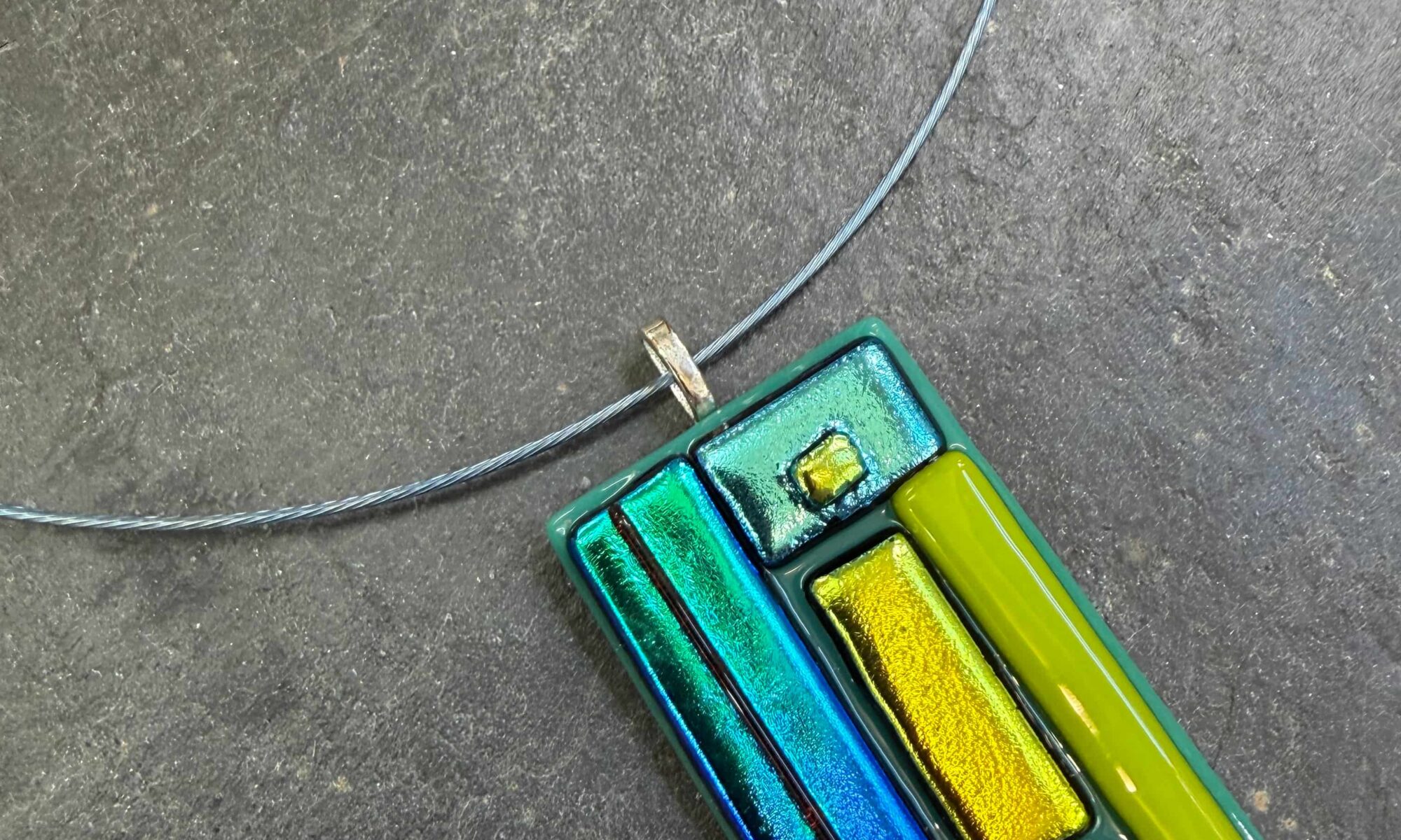 Fused Glass Dichroic Pendant in blue, green and gold, a lovely example of profile fused glass at Rainbow Glass Studios on the beginners fused glass jewellery course
