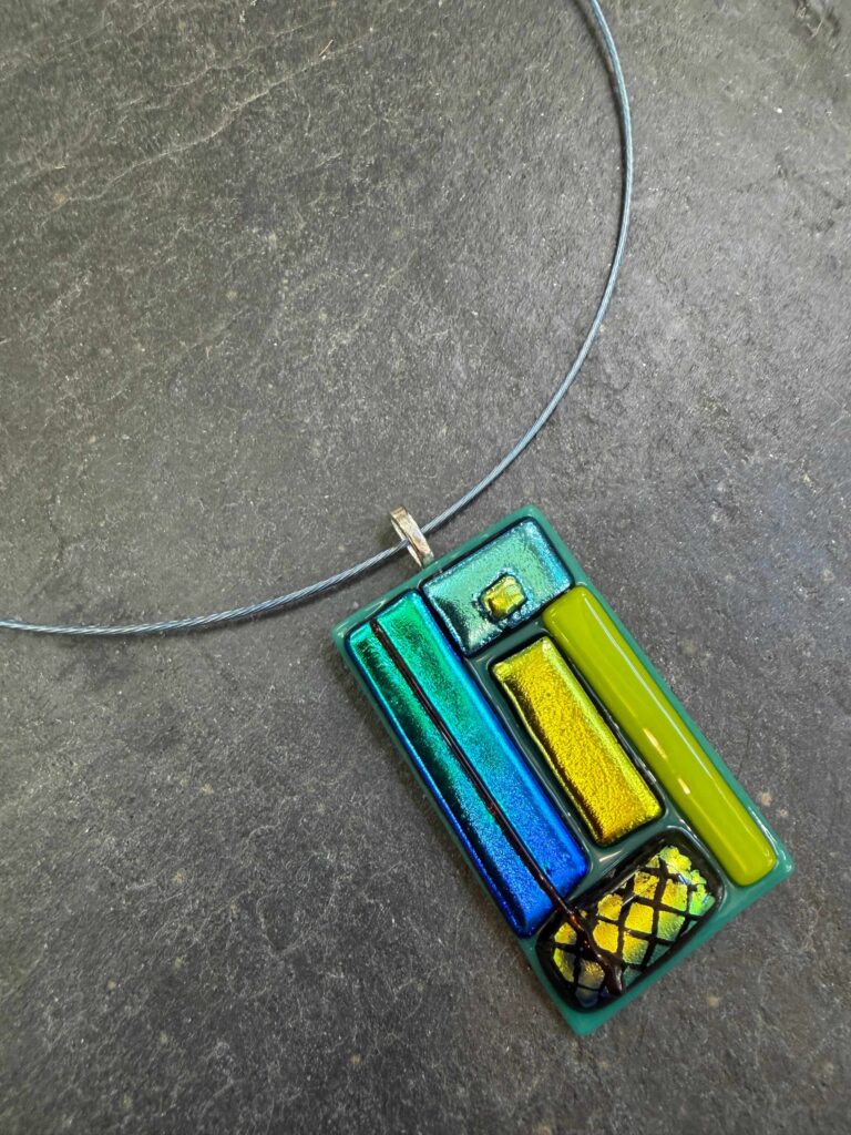 Fused Glass Dichroic Pendant in blue, green and gold, a lovely example of profile fused glass at Rainbow Glass Studios on the beginners fused glass jewellery course